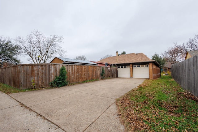 exterior space featuring a garage and solar panels