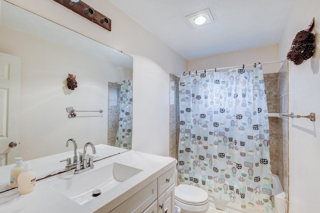 full bathroom with shower / tub combo with curtain, vanity, and toilet