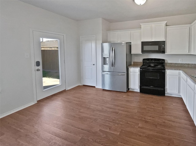 kitchen with dark hardwood / wood-style flooring, white cabinetry, and black appliances