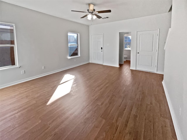 empty room featuring dark hardwood / wood-style flooring and ceiling fan