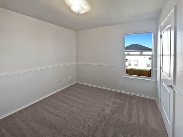 empty room featuring dark colored carpet