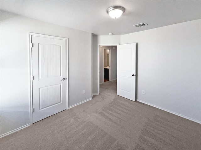 unfurnished bedroom with a closet and carpet floors