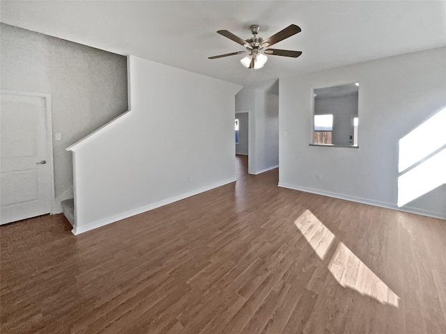 unfurnished living room featuring ceiling fan and dark hardwood / wood-style flooring