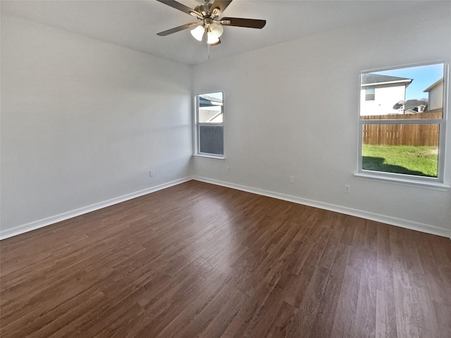 unfurnished room featuring dark hardwood / wood-style floors and ceiling fan