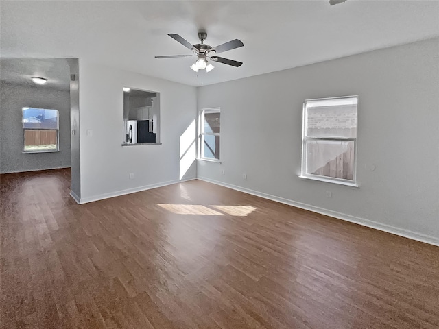 empty room featuring ceiling fan and dark hardwood / wood-style floors