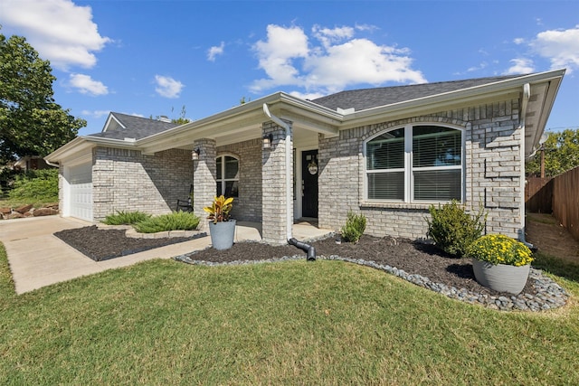 ranch-style house with a front yard and a garage