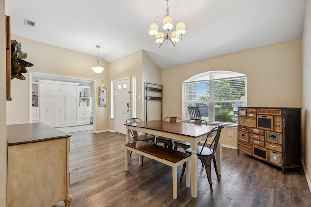 dining area with an inviting chandelier, lofted ceiling, and dark hardwood / wood-style floors