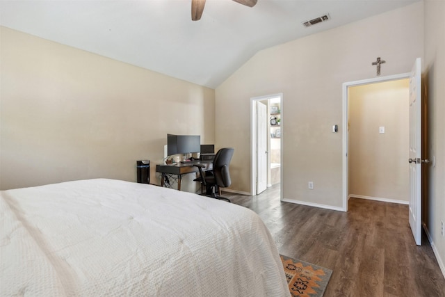 bedroom featuring dark hardwood / wood-style floors, ceiling fan, lofted ceiling, and a walk in closet