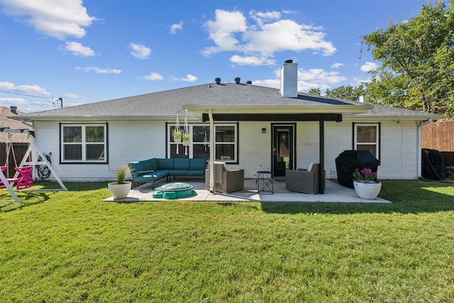 rear view of house with outdoor lounge area, a patio, and a lawn