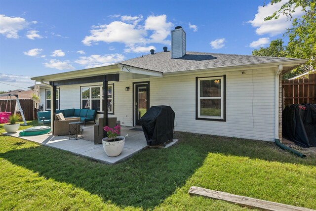 rear view of property with a lawn, outdoor lounge area, and a patio area