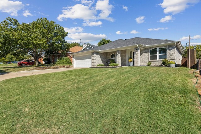 single story home with a garage and a front lawn