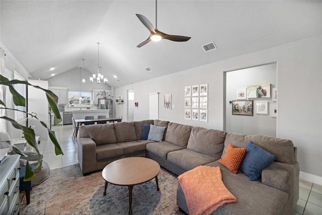 tiled living room featuring ceiling fan with notable chandelier and lofted ceiling