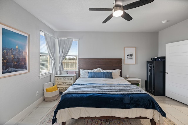 tiled bedroom featuring ceiling fan