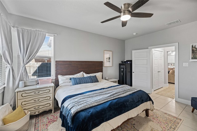 bedroom with ceiling fan and light tile patterned floors