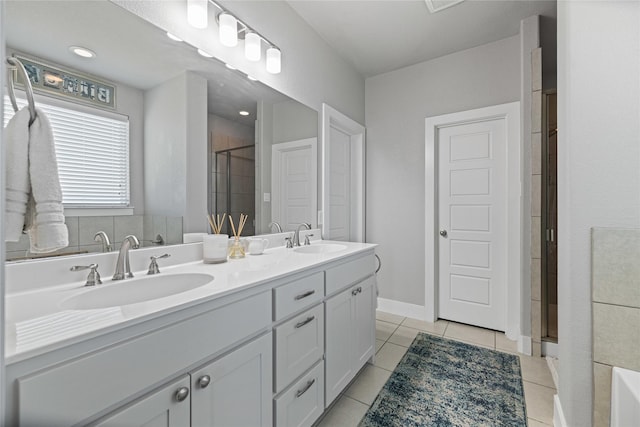 bathroom with tile patterned floors, vanity, and an enclosed shower