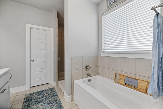 bathroom with tile patterned flooring, vanity, and shower with separate bathtub