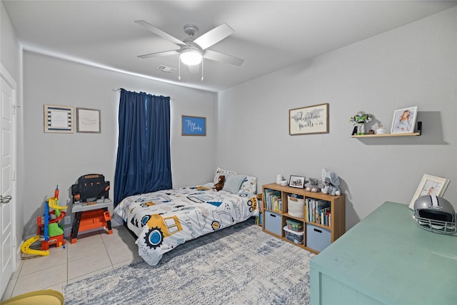 tiled bedroom featuring ceiling fan