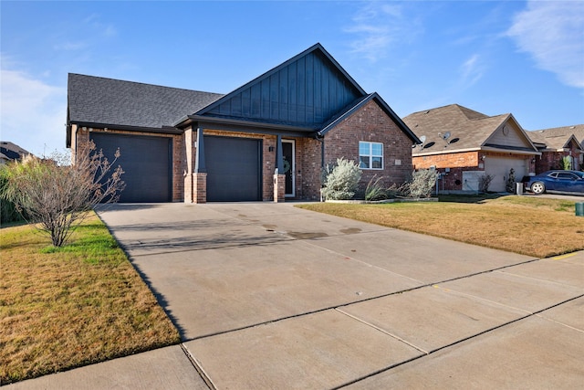 view of front of property with a front yard and a garage