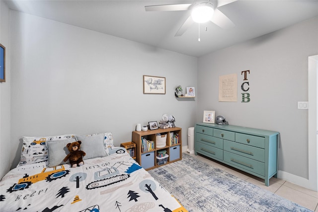 tiled bedroom featuring ceiling fan