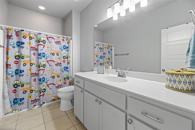 bathroom with tile patterned flooring, vanity, and toilet