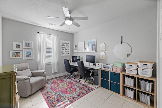 home office with ceiling fan, light tile patterned floors, and a textured ceiling