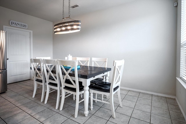 dining room featuring light tile patterned floors and an inviting chandelier