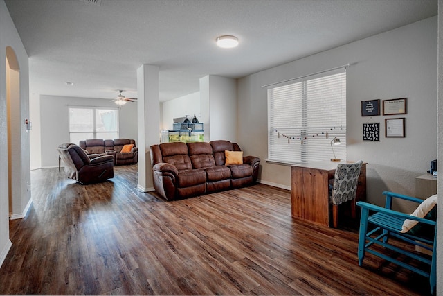 living room with dark hardwood / wood-style floors and ceiling fan