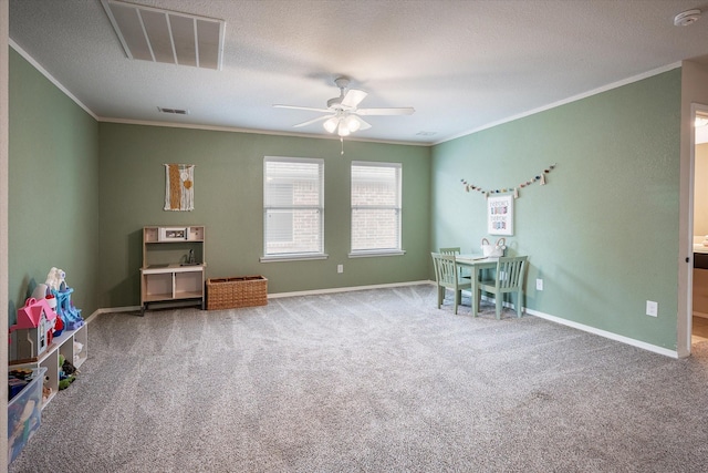 recreation room with carpet, ceiling fan, crown molding, and a textured ceiling