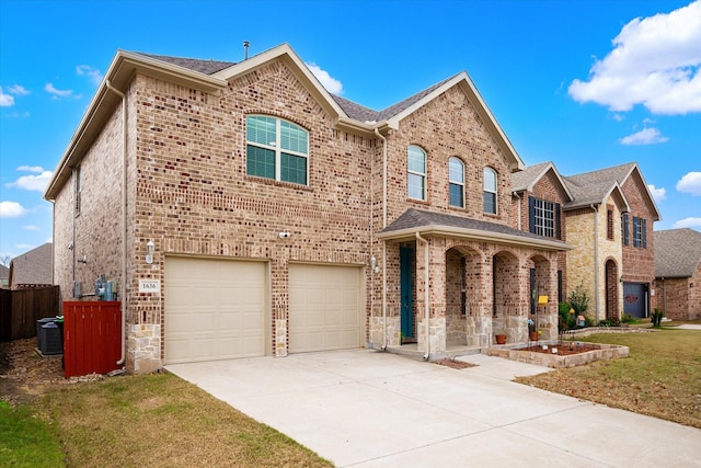 view of front of home with a front lawn, a garage, and central AC unit