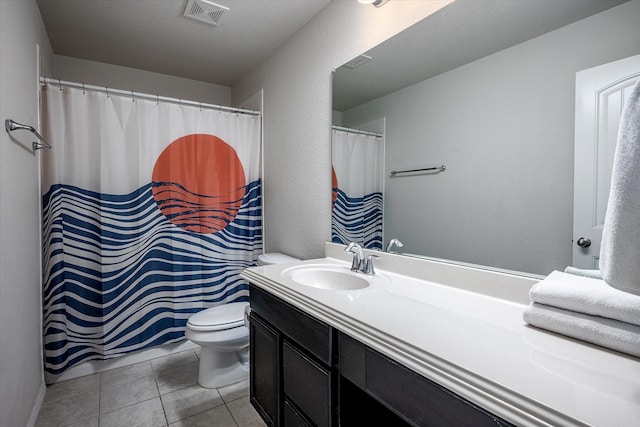 bathroom with tile patterned floors, vanity, and toilet