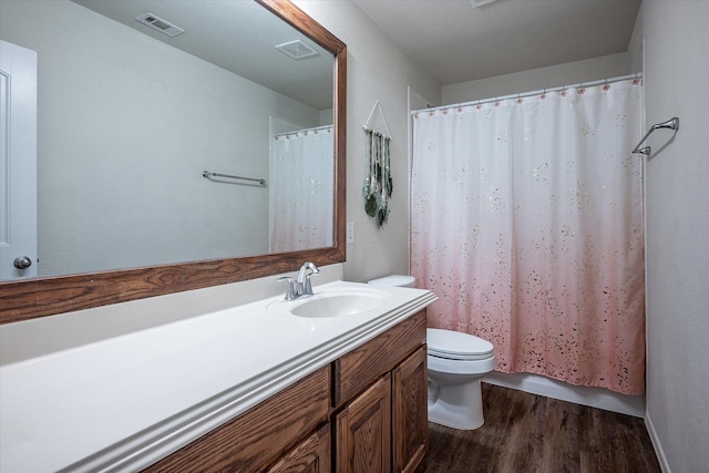 bathroom featuring vanity, toilet, and wood-type flooring