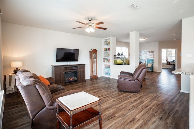 living room with dark hardwood / wood-style floors and ceiling fan