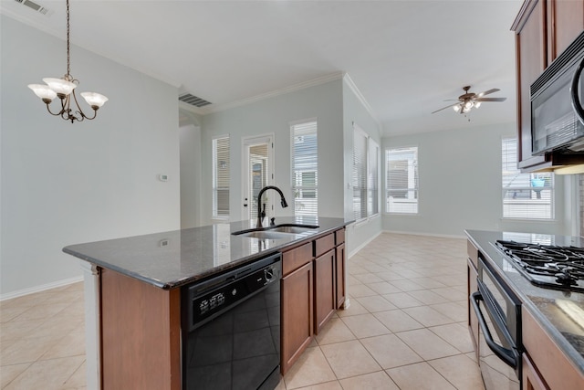 kitchen with black appliances, pendant lighting, dark stone countertops, and sink