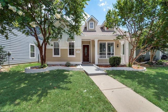 view of front of property with covered porch and a front yard