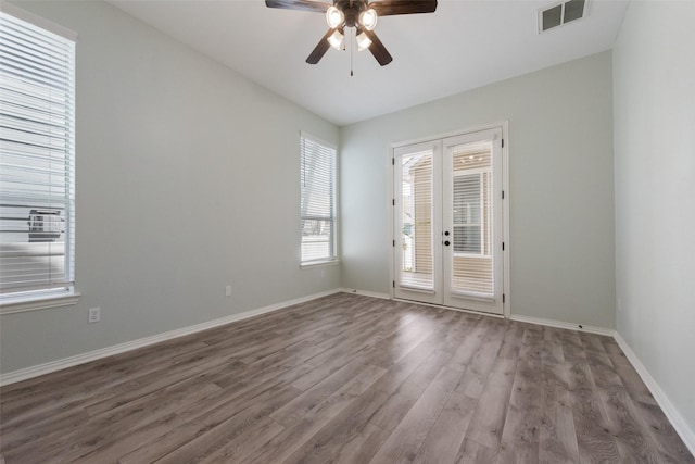 unfurnished room with ceiling fan, french doors, and hardwood / wood-style flooring