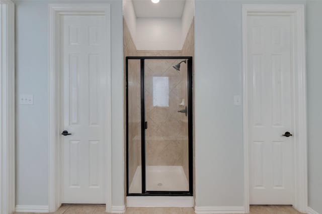 bathroom featuring a shower with shower door