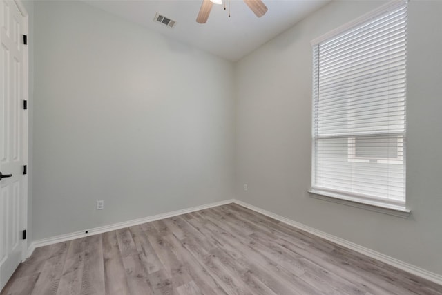 spare room featuring light hardwood / wood-style floors, vaulted ceiling, and ceiling fan