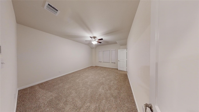 empty room featuring ceiling fan and light colored carpet