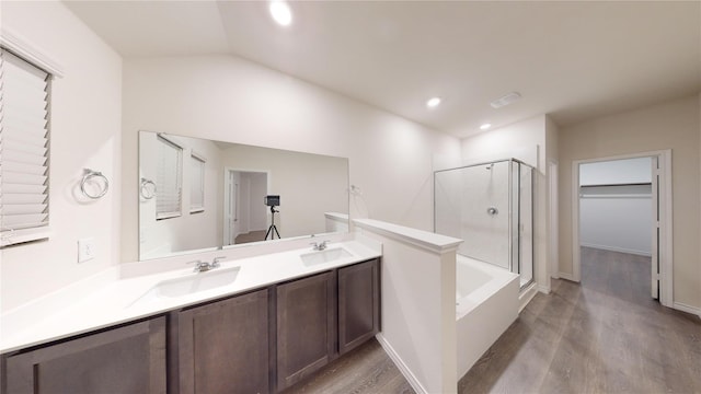 bathroom featuring hardwood / wood-style flooring, vanity, independent shower and bath, and vaulted ceiling