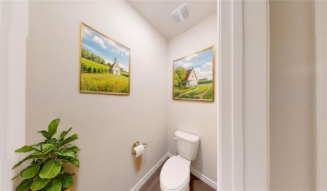 bathroom with hardwood / wood-style floors and toilet