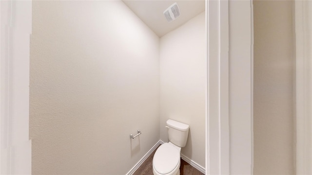 bathroom with toilet and lofted ceiling