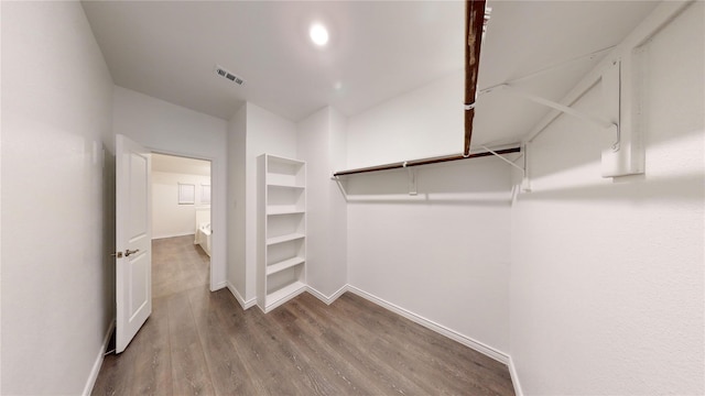 spacious closet with hardwood / wood-style floors