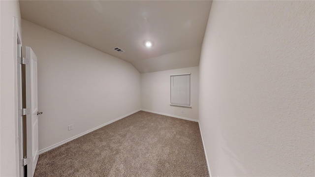 additional living space featuring carpet and lofted ceiling