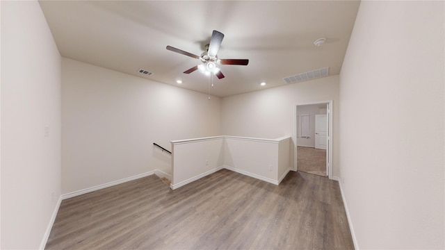 spare room with ceiling fan and light wood-type flooring