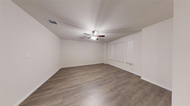 spare room with ceiling fan and dark hardwood / wood-style flooring