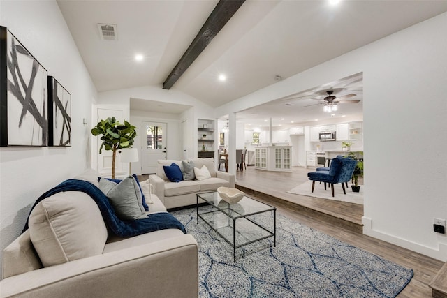 living room with wood-type flooring, vaulted ceiling with beams, and ceiling fan