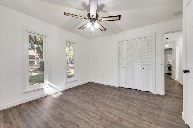 unfurnished bedroom featuring dark hardwood / wood-style flooring and ceiling fan