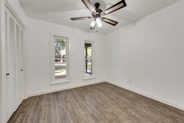 spare room featuring ceiling fan and dark hardwood / wood-style flooring