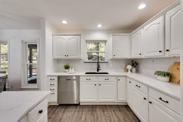 kitchen featuring decorative backsplash, dark hardwood / wood-style flooring, white cabinets, sink, and dishwasher