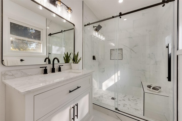 bathroom with vanity and a shower with shower door